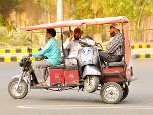 E-Rickshaw carrying Scooter and 3 persons